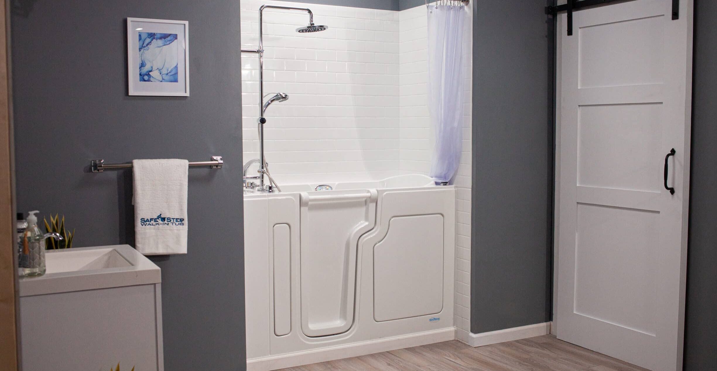 walk-in tub shower combo with surrounding grey walls