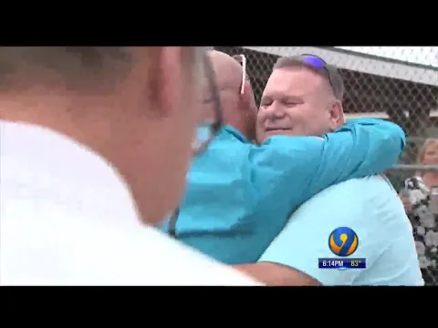 Safe Step worker hugging man who received a walk-in tub