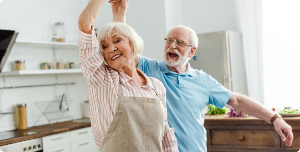 Elderly couple dancing in the kitchen