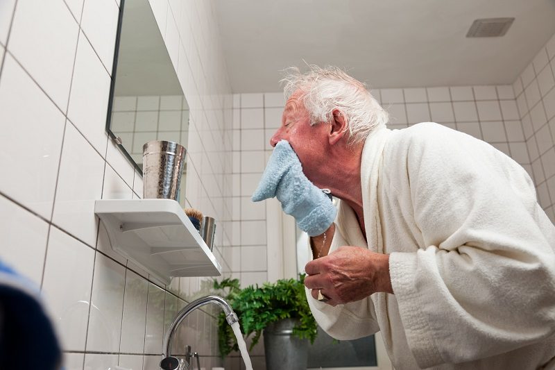 man cleaning his face after shaving