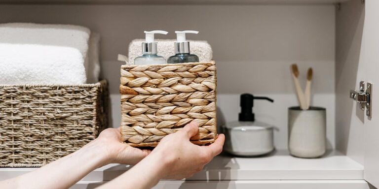 placing a wicker basket on a bathroom shelf
