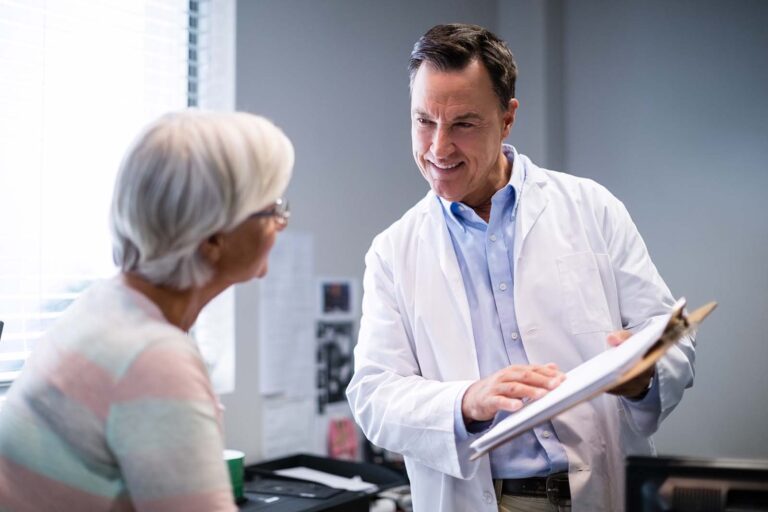 doctor speaking with an elderly woman