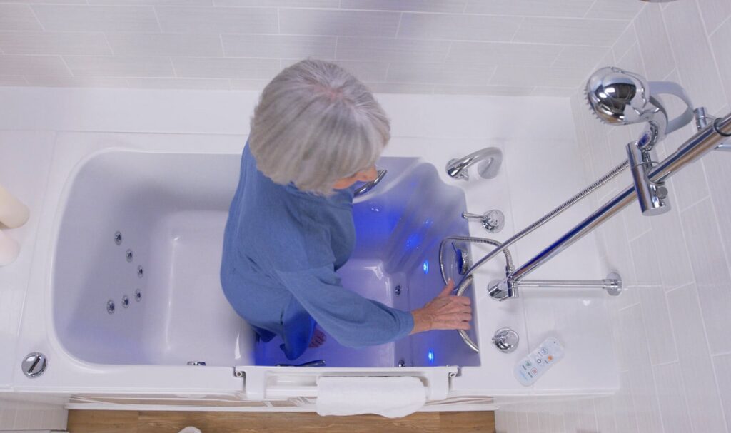 woman using the safety grab bar to easily stand up in the walk-in tub