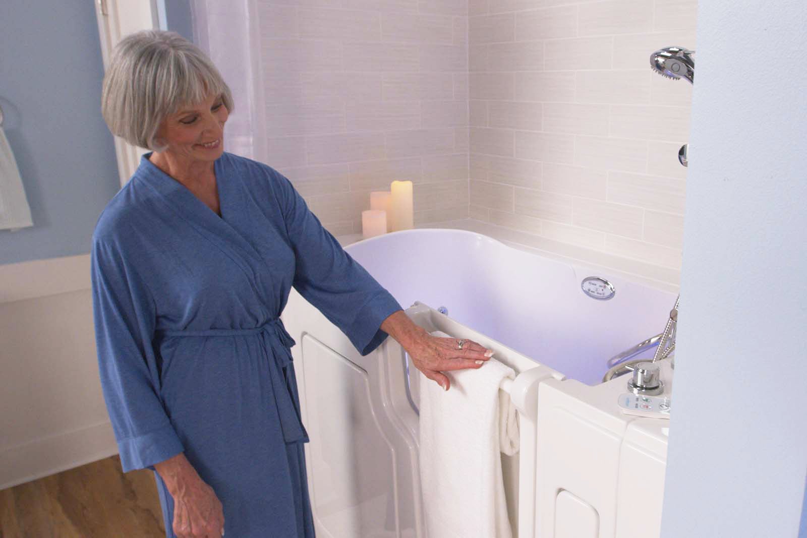 woman putting a towel on the towel bar