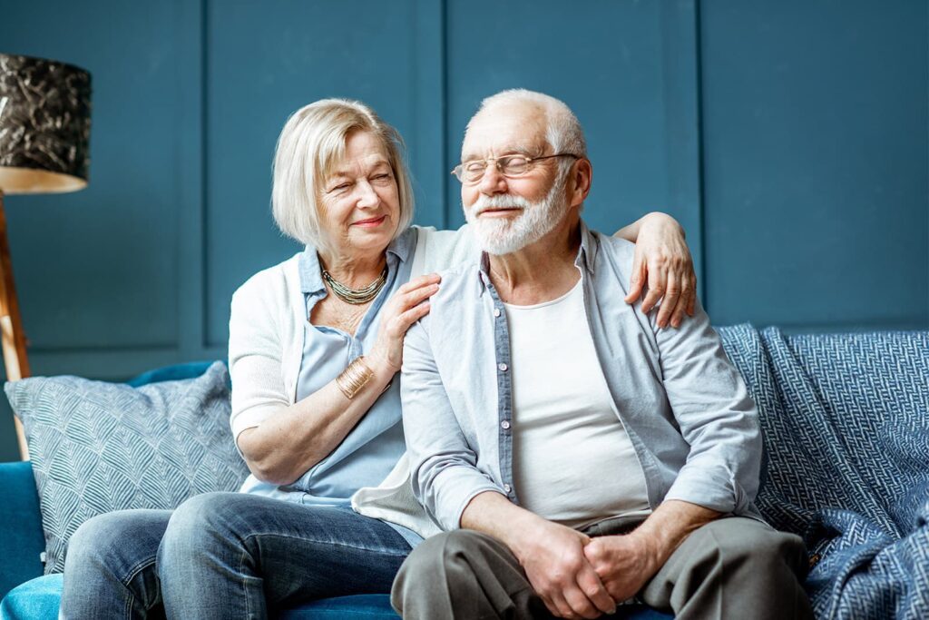 old couple sitting on the couch together