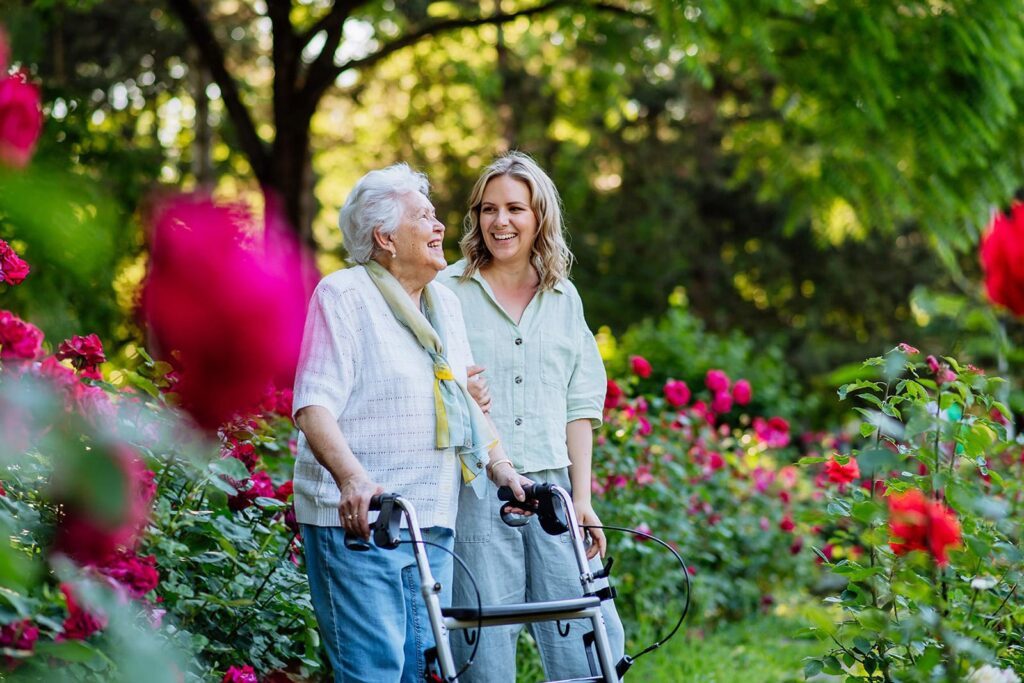 woman walking with and elderly woman with a walker