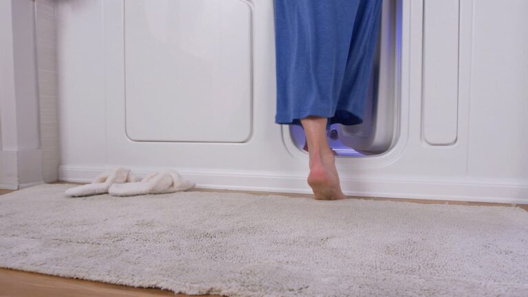 woman stepping over the low-threshold walk-in tub