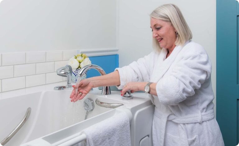 Woman in a bathrobe filling her walk-in tub with the rapid fill faucet