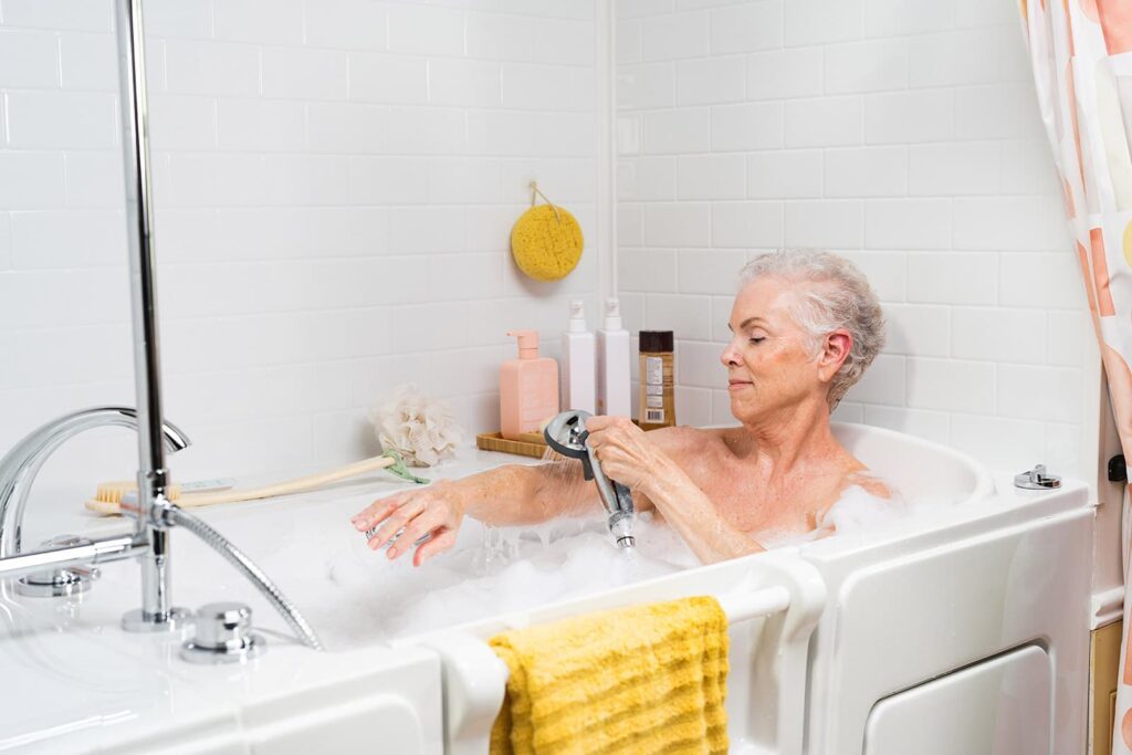 woman using the handheld shower wand