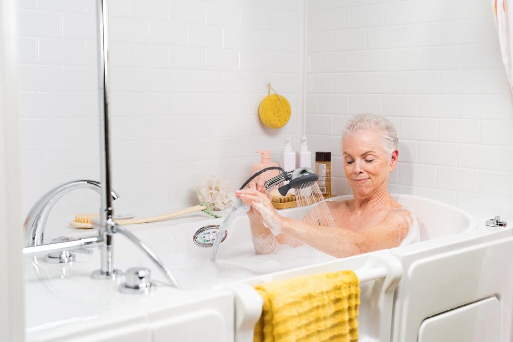 woman using the handheld shower wand